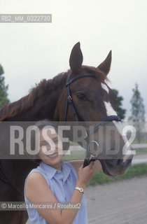 Modena, 1999. Luciano Pavarottis wife, Nicoletta Mantovani with a horse of Pavarotti stable / Modena, 1999. La moglie di Luciano Pavarotti, Nicoletta Mantovani con un cavallo della scuderia Pavarotti - ©Marcello Mencarini/Rosebud2