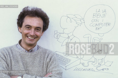 Lucca, 1984. Italian cartoonist Luca Novelli posing next to one of his drawing / Lucca, 1984. Il disegnatore di fumetti Luca Novelli posa accanto a un suo disegno - ©Marcello Mencarini/Rosebud2