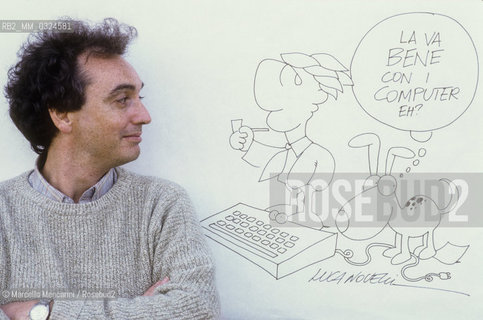 Lucca, 1984. Italian cartoonist Luca Novelli posing next to one of his drawing / Lucca, 1984. Il disegnatore di fumetti Luca Novelli posa accanto a un suo disegno - ©Marcello Mencarini/Rosebud2