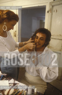 Pesaro, Rossini Opera Festival 1984. Italian opera singer baritone Leo Nucci in his dressing room before performing in Il viaggio a Reims (The Jorney to Reims) by Gioacchino Rossini / Pesaro, Rossini Opera Festival 1984. Il cantante lirico Leo Nucci nel suo camerino prima di cantare in Il viaggio a Reims di Gioacchino Rossini - ©Marcello Mencarini/Rosebud2