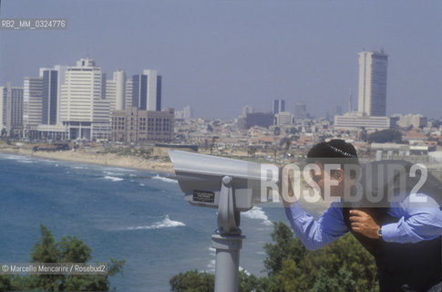 Tel Aviv, 1991. Israeli conductor Daniel Oren and his wife Shulamith Orvieto looking at the panorama through binoculars / Tel Aviv, 1991. Il direttore dorchestra Daniel Oren e sua moglie Shulamith Orvieto mentre guardano il panorama con un binocolo - ©Marcello Mencarini/Rosebud2