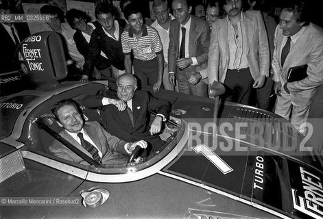 Modena, 1979. Politicians members of the Italian Christian Democracy Party Flaminio Piccoli and Amintore Fanfani in a rally car at the Festa dellAmicizia (Friendship Festival), the annual meeting of their party / Modena, 1979. I politici democristiani Flaminio Piccoli e Amintore Fanfani in un auto da rally alla Festa dellAmicizia, raduno annuale del loro partito - ©Marcello Mencarini/Rosebud2