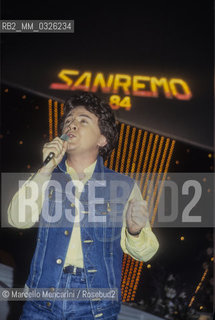 Sanremo Music Festival 1984. Italian pop singer Enzo Ghinazzi, knows as Pupo, performing the song Un amore grande (a great love) - Festival di Sanremo, 1984. Il cantante Enzo Ghinazzi (Pupo) al Festival con la canzone Un amore grande - ©Marcello Mencarini/Rosebud2