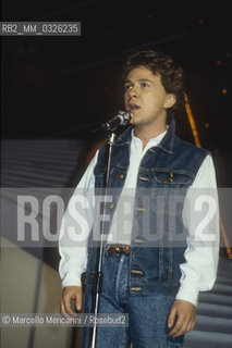 Sanremo Music Festival 1984. Italian pop singer Enzo Ghinazzi, knows as Pupo, performing the song Un amore grande (a great love) - Festival di Sanremo, 1984. Il cantante Enzo Ghinazzi (Pupo) al Festival con la canzone Un amore grande - ©Marcello Mencarini/Rosebud2