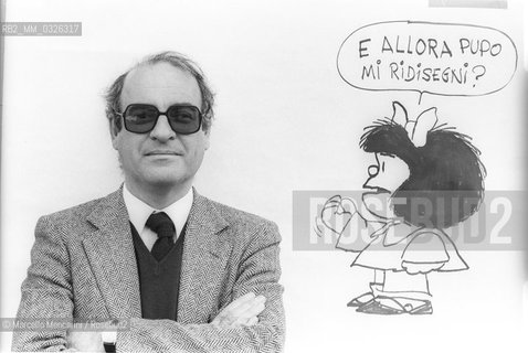 Lucca, 1984. Argentinian cartoonist Quino posing next to a drawing of his character Mafalda / Lucca, 1984. Il fumettista Quino posa accanto al un disegno del suo personaggio Mafalda - ©Marcello Mencarini/Rosebud2