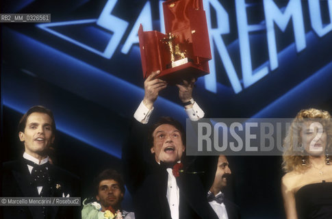 Sanremo Music Festival 1988. Italian pop singer Massimo Ranieri, winner of the Festival with the song Perdere lAmore, with TV presenters Miguel Bosé and Gabriella Carlucci / Festival di Sanremo 1988. Massimo Ranieri, vincitore del Festival con la canzone Perdere lamore, e i presentatori TV Miguel Bosé e Gabriella Carlucci - ©Marcello Mencarini/Rosebud2