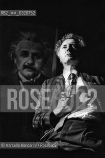 Italian physicist Tullio Regge during a lesson with a portrait of Albert Einstein in the Background (1981) / Il fisico Tullio Regge durante una lezione con un ritratto di Albert Einstein sullo sfondo (1981) - ©Marcello Mencarini/Rosebud2