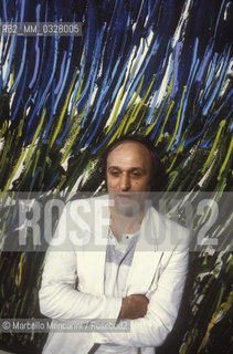 Venice, 1984. Italian artist Mario Schifano in front of one of his paintings / Venezia, 1984. Lartista Mario Schifano davanti a uno dei suoi quadri - ©Marcello Mencarini/Rosebud2