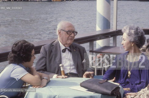 Venice, 1980. Classical guitarist Andrés Segovia - in Venice to receive the A Life for Music  award - on the terrace of the Hotel Bauer on the Grand Canal (in front of the Basilica of St Mary of Health) with his son Carlos Andrés and his wife Emilia Corral Sancho / Venezia, 1980. Il chitarrista classico Andrés Segovia - a Venezia per ricevere il premio Una vita per la musica - sulla terrazza dellHotel Bauer sul Canal Grande (di fronte alla Basilica della Salute) con il figlio Carlos Andrés e la moglie Emilia Corral Sancho - ©Marcello Mencarini/Rosebud2