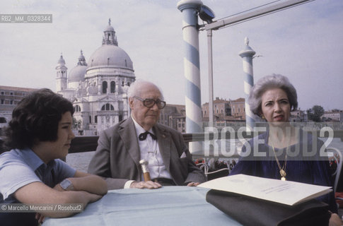 Venice, 1980. Classical guitarist Andrés Segovia - in Venice to receive the A Life for Music  award - on the terrace of the Hotel Bauer on the Grand Canal (in front of the Basilica of St Mary of Health) with his son Carlos Andrés and his wife Emilia Corral Sancho / Venezia, 1980. Il chitarrista classico Andrés Segovia - a Venezia per ricevere il premio Una vita per la musica - sulla terrazza dellHotel Bauer sul Canal Grande (di fronte alla Basilica della Salute) con il figlio Carlos Andrés e la moglie Emilia Corral Sancho - ©Marcello Mencarini/Rosebud2