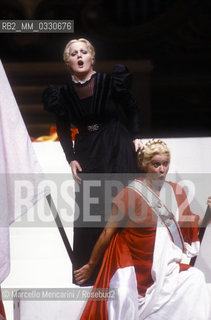 Pesaro, August 18, 1984. Rossini Opera Festival. Mezzo-soprano Lucia Valentini Terrani as Marchesa Melibea and soprano Katia Ricciarelli as Madame Cortese in Il viaggio a Reims (The Jorney to Reims) by Gioacchino Rossini. This is the first performance of that opera staged by Luca Ronconi and conducted by Claudio Abbado, after the reconstruction of its manuscript, assumed lost, in the 1970s / Pesaro, 18 agosto 1984. Rossini Opera Festival. Il mezzosoprano Lucia Valentini Terrani nel ruolo della Contessa Melibea e Il soprano Katia Ricciarelli nel ruolo di Madame Cortese ne Il viaggio a Reims di Gioacchino Rossini. E la prima rappresentazione dellopera con la regia di Luca Ronconi e la direzione dorchestra di Clauio Abbado, dopo il ritrovamento e la ricomposizione negli anni 70 del suo manoscritto che si credeva perduto - ©Marcello Mencarini/Rosebud2