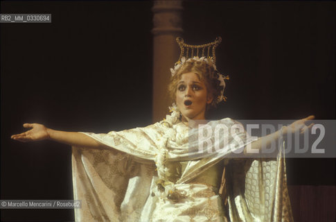 Pesaro, August 18, 1984. Rossini Opera Festiva. Soprano Cecilia Gasdia as Corinna in Il viaggio a Reims (The Jorney to Reims) by Gioacchino Rossini. This is the first performance of that opera, staged by Luca Ronconi and conducted by Claudio Abbado, after the reconstruction of its manuscript, assumed lost, in the 1970s / Pesaro, 18 agosto 1984. Rossini Opera Festival. Il soprano Cecilia Gasdia nel ruolo di Corinna in Il viaggio a Reims di Gioacchino Rossini. E la prima rappresentazione dellopera, con la regia di Luca Ronconi e la direzione dorchestra di Claudio Abbado, dopo il ritrovamento e la ricomposizione negli anni 70 del suo manoscritto che si credeva perduto - ©Marcello Mencarini/Rosebud2