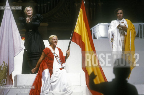 Pesaro, August 18, 1984. Rossini Opera Festival. Soprano Katia Ricciarelli as Madame Cortese, mezzo-soprano Lucia Valentini Terrani as Marchesa Melibea and bass-baritone Ruggero Raimondi as Don Profondo in Il viaggio a Reims (The Jorney to Reims) by Gioacchino Rossini. This is the first performance of that opera staged by Luca Ronconi and conducted by Claudio Abbado, after the reconstruction of its manuscript, assumed lost, in the 1970s / Pesaro, 18 agosto 1984. Rossini Opera Festival. Il soprano Katia Ricciarelli nel ruolo di Madame Cortese, il mezzosoprano Lucia Valentini Terrani nel ruolo della contessa Melibea e il basso baritono Ruggero Raimondi nel ruolo di Don Profondo ne Il viaggio a Reims di Gioacchino Rossini. E la prima rappresentazione dellopera con la regia di Luca Ronconi e la direzione dorchestra di Claudio Abbado, dopo il ritrovamento e la ricomposizione negli anni 70 del suo manoscritto che si credeva perduto - ©Marcello Mencarini/Rosebud2