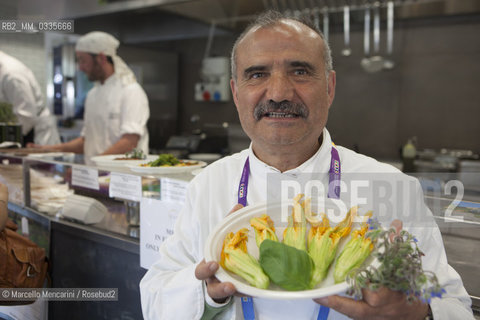 Milan Expo 2015. Mr Peppe Zullo, chef-farmer at Orsara di Puglia near Foggia, Italy, proposes his Squash blossoms with caciocavallo cheese from Mountains of Daunia and basil at the Puglia region restaurant in the Eataly space  /  Expo Milano 2015. Il signor Peppe Zullo, coltivatore e chef ad Orsara di Puglia (Foggia), propone i suoi  Fiori di zucca con caciocavallo dei Monti Dauni e basilico presso iil ristorante della regione Puglia nello spazio Eataly - ©Marcello Mencarini/Rosebud2