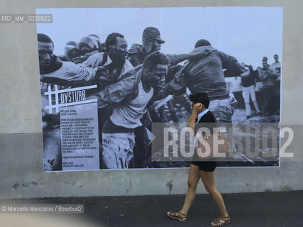 Perpignan, France, 2015. Visa pour limage, International Festival of Photojournalism: #disturb, photo by Gianfranco Tripodo - about Subsaharan migrants escaping from the police in Melilla, Spain (April 24, 2014 ) - pasted on a wall near the Couvent of Minimes / Perpignan, Francia, 2015. Visa pour limage, Festival internazionale del fotogiornalismo: #disturb, foto di Gianfranco Tripodo - sui migranti subsahariani che scappano dalla polizia a Melilla, in Spagna (aprile 2014) - incollata su un muro vicino al Couvent des Minimes - ©Marcello Mencarini/Rosebud2