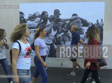 Perpignan, France, 2015. Visa pour limage, International Festival of Photojournalism: #disturb, photo by Gianfranco Tripodo - about Subsaharan migrants escaping from the police in Melilla, Spain (April 24, 2014 ) - pasted on a wall near the Couvent of Minimes / Perpignan, Francia, 2015. Visa pour limage, Festival internazionale del fotogiornalismo: #disturb, foto di Gianfranco Tripodo - sui migranti subsahariani che scappano dalla polizia a Melilla, in Spagna (aprile 2014) - incollata su un muro vicino al Couvent des Minimes - ©Marcello Mencarini/Rosebud2