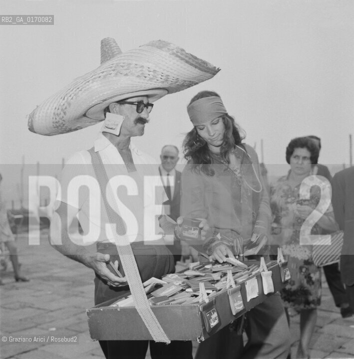 CINEMA / LATTRICE NICOLETTA RANGONI MACCHIAVELLI (ITALIA) A VENEZIA / MENTRE COMPRA UN BORSELLINO DA UN VENDITORE DI SOUVENIRS CON IL SOMBRERO / MOSTRA INTERNAZIONALE DARTE CINEMATOGRAFICA, BIENNALE 1969 - © ARCHIVIO Graziano Arici/Rosebud2 .