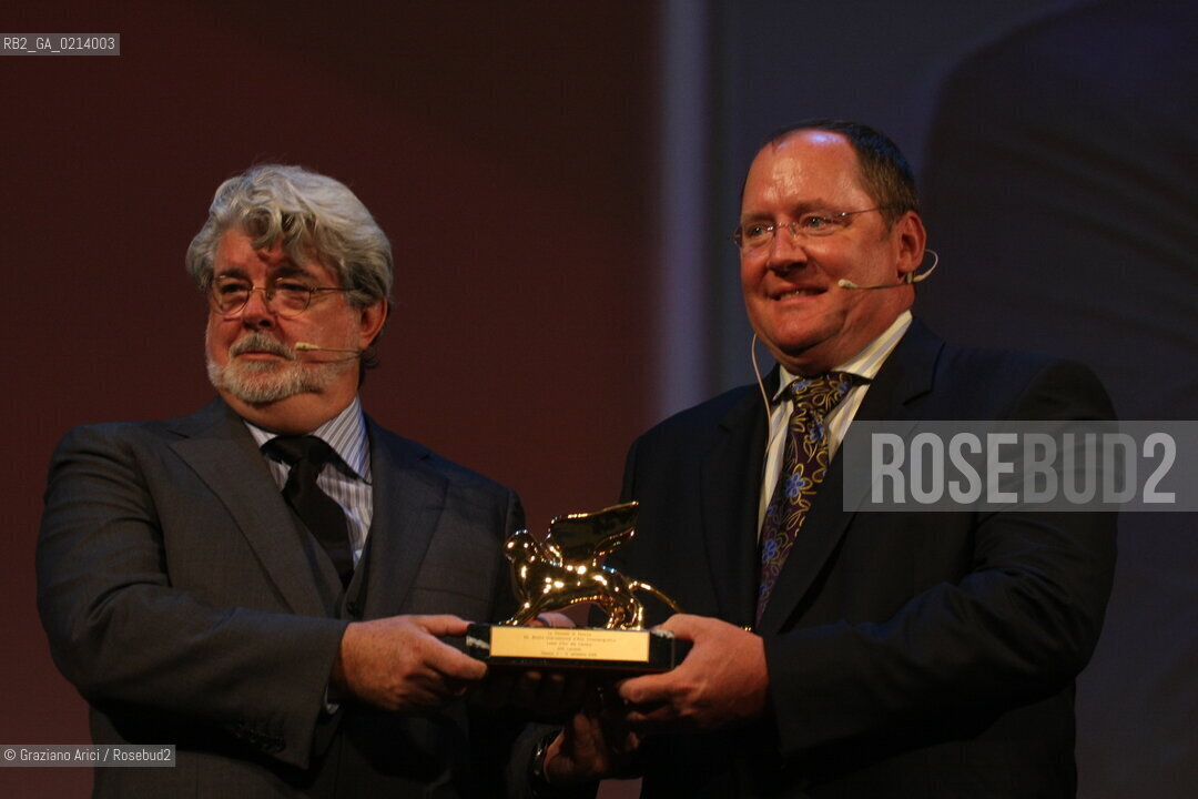 Italy, Venice - September 06th, 2009.66th VENICE INTERNATIONAL FILM FESTIVAL - GOLDEN LION FOR LIFETIME ACHIEVEMENT TO JOHN LASSETER AND THE PIXAR DIRECTORS..THE DIRECTOR GEORGE LUCAS HAND IN THE GLODEN LION TO JOHN LASSETER