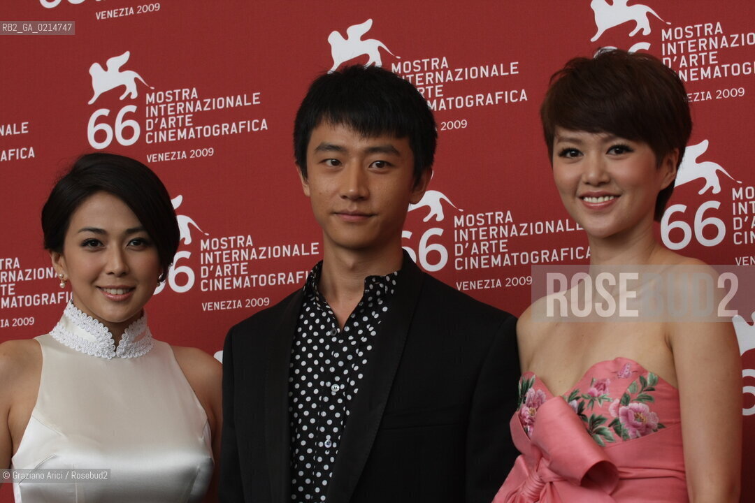 Italy, Venice - September 12th, 2009.66th VENICE INTERNATIONAL FILM FESTIVAL - FILM: CHENGDU, WO AI NI (CHENGDU, I LOVE YOU). THE ACTOR HUANG XUAN BETWEEN WU ANYA (LEFT) AND TAN WEIWEI.. ©Graziano Arici/Rosebud2
