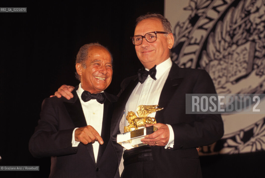 - Venezia, 1995. 52°Festival Internazionale dArte Cinematografica di Venezia. Ritratto del compositore Ennio Morricone, Leone dOro alla Carriera, mentre riceve il premio dal direttore della mostra del cinema Gillo Pontecorvo. Musica Cinema Compositore ritratto Leone dOro.- Venice,1995. 52th Venice International Film Festival. Portrait of the composer Ennio Morricone, Golden Lion for Lifetime Archievement, with the director of the Film Festival Gillo Pontecorvo ©  Graziano Arici
