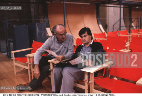 -Venezia,1984.Chiesa di San Lorenzo. Opera del compositore contemporaneo Luigi Nono, Prometeo - Tragedia dellascolto prova generale, testo di Massimo Cacciari, struttura scenica dellarchitetto Renzo Piano, luci del pittore Emilio Vedova.Il compositore Luigi Nono durante le prove con Roberto Fabbriciani. musica compositore opera Prometeo contemporanea elettronica filosofia architettura pittura ritratto.-Venice,1984. Work  Prometeo - Tragedia dellascolto directed by contemporary composer Luigi Nono,text by the philosopher Massimo Cacciari,scenography by the architect Renzo Piano,stage lighting by the painter Emilio Vedova. Portrait of the composer Luigi Nono with Roberto Fabbriciani ©Graziano Arici/Rosebud2