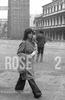 CINEMA / LATTRICE MARIA SCHNEIDER A VENEZIA MENTRE PASSEGGIA IN PIAZZA SAN MARCO / CON IN MANO UN GIORNALE / 1974 - © ARCHIVIO Graziano Arici/Rosebud2 