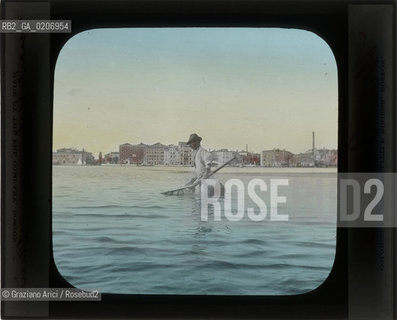 -VENEZIA, THE ERL COMPANY, BOSTON, COLORED BY EDWARD LITTLE ROGERS, BOSTON, PESCATORE, SENZA DATA. LASTRA IN VETRO PER LANTERNA MAGICA COLORATA A MANO 10X8,2 ©ARCHIVIO Graziano Arici/Rosebud2  MESTIERI, PERSONA, FOTOANTICHE.-VENICE, THE ERL COMPANY, BOSTON, COLORED BY EDWARD LITTLE ROGERS, BOSTON, PESCATORE, UNDATED. GLASS SLIDE FOR MAGIC LANTERN HAND COLOURED, CM 10X8,2 ©Graziano Arici/Rosebud2 