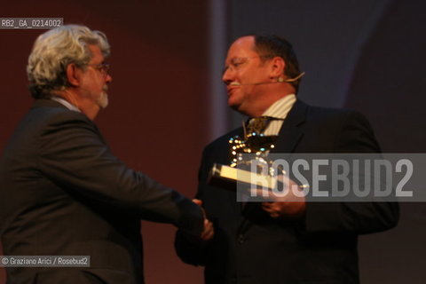 Italy, Venice - September 06th, 2009.66th VENICE INTERNATIONAL FILM FESTIVAL - GOLDEN LION FOR LIFETIME ACHIEVEMENT TO JOHN LASSETER AND THE PIXAR DIRECTORS..THE DIRECTOR GEORGE LUCAS HAND IN THE GLODEN LION TO JOHN LASSETER