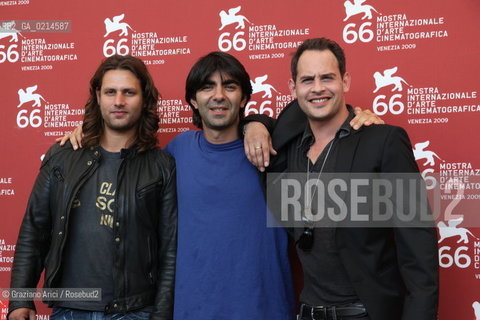 Italy, Venice - September 10th, 2009.66th VENICE INTERNATIONAL FILM FESTIVAL - FILM: SOUL KITCHEN. THE DIRECTOR FATIH AKIN BETWEEN THE ACTORS ADAM BOUSDOUKOS (LEFT) AND MORITZ BLEIBTREU