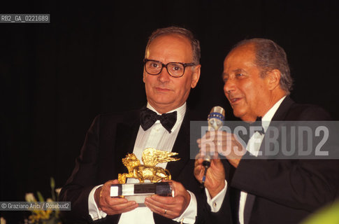 - Venezia, 1995. 52°Festival Internazionale dArte Cinematografica di Venezia. Ritratto del compositore Ennio Morricone, Leone dOro alla Carriera, mentre riceve il premio dal direttore della mostra del cinema Gillo Pontecorvo. Musica Cinema Compositore ritratto Leone dOro.- Venice,1995. 52th Venice International Film Festival. Portrait of the composer Ennio Morricone, Golden Lion for Lifetime Archievement, with the director of the Film Festival Gillo Pontecorvo ©  Graziano Arici