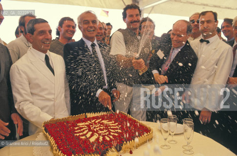 Venezia,1990.Festa Il Moro di Venezia. Il presidente della Montedison Raul Gardini mentre taglia la torta e lo skipper Paul Pierre Cayard.  .Venice,1990.Party The Moro of Venice.The Montedison President Raul Gardini and the skipper Paul Pierre Cayard ©Graziano Arici/Rosebud2
