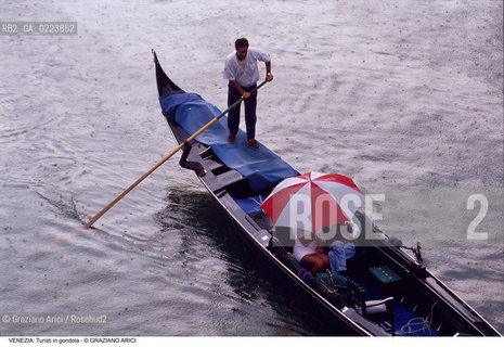 Localizzazione:..VENEZIA / S. MARCO..Oggetto:..Soggetto:..TURISTI IN GONDOLA / PIOGGIA..Cronologia: ..Definizione Culturale:..   Autore: ..   Stile: ..   Editori/Stampatori:..   Committenza:..Materia e Tecnica:..Collocazione:..Note:..TURISMO..Riproduzione Fotografica:..Copyright:..Graziano Arici/Rosebud2 .Data:..1990..Costo:..A
