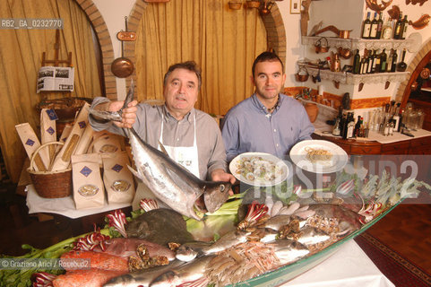 CAVALLINO (VENICE) ITALY - 25 FEBRUARY 2004: LAGUNA RESTAURANT - THE RESTAURATEUR OLINDO BALLARIN (LEFT) WITH A SICILIAN TUNA FISH  AND HIS SON ALVISE BALLARIN WITH CANESTRELLI (GRILLED RAZOR CLAMS,LEFT) AND BIGOLI IN SALSA (HOME MADE PASTA WITH ONIONS AND ANCHOVY, RIGHT) ©Graziano Arici/Rosebud2 GASTRONOMIA