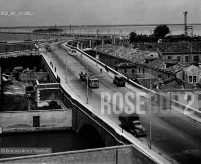 -Venezia, post anni 30, Ponte della Libertà. Vista da Santa Chiara del Ponte della Libertà (ponte Littorio), senza indicazione dellautore,stampa ai sali dargento, 19,5x24 cm..-Venice, after 1933, Ponte della Libertà, panoramic view of the Ponte della Libertà and Santa Chiara,no authors indication, silver salt print ,19,5x24 cm -Archivio Graziano Arici..LArchivio Arici non è riuscito ad avere informazioni sullautore di questa foto. Siamo comunque a disposizione di qualunque avente diritto per riconoscere eventuali proprietà intellettuali che non sia stato possibile fin qui attribuire. .Qualora si fosse inavvertitamente leso qualsiasi diritto di riproduzione, si prega di contattare lArchivio che provvederà a rimuovere le immagini in questione..La cessione dei diritti di questa immagine si intende per quanto di nostra competenza. Non comprende invece le eventuali spese  relative a diritti che potranno essere richiesti dagli Enti o persone fisiche cui appartengono eventualmente i soggetti  ripresi. Tali costi, ove necessari, e l’espletamento di qualsivoglia pratica di richiesta di concessione del permesso di pubblicazione sono esclusivamente a carico e a cura del soggetto acquirente di questa immagine..  astga ©Graziano Arici/Rosebud2