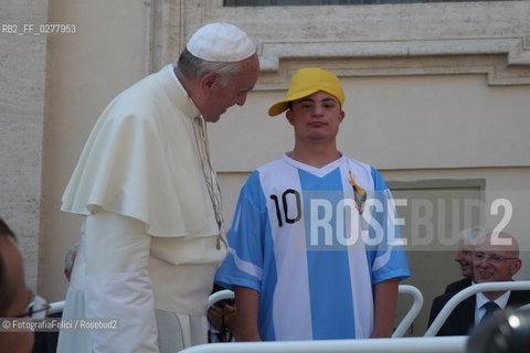 Rome, Vatican City, Pope Francis with a boy with a disability on the papal jeep, june 19, 2013. ©FotografiaFelici/Rosebud2