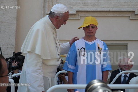 Rome, Vatican City, Pope Francis with a boy with a disability on the papal jeep, june 19, 2013. ©FotografiaFelici/Rosebud2