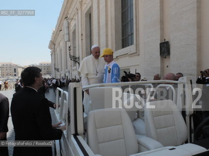 Rome, Vatican City, Pope Francis with a boy with a disability on the papal jeep, june 19, 2013. ©FotografiaFelici/Rosebud2