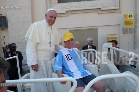 Rome, Vatican City, Pope Francis with a boy with a disability on the papal jeep, june 19, 2013. ©FotografiaFelici/Rosebud2