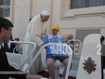 Rome, Vatican City, Pope Francis with a boy with a disability on the papal jeep, june 19, 2013. ©FotografiaFelici/Rosebud2
