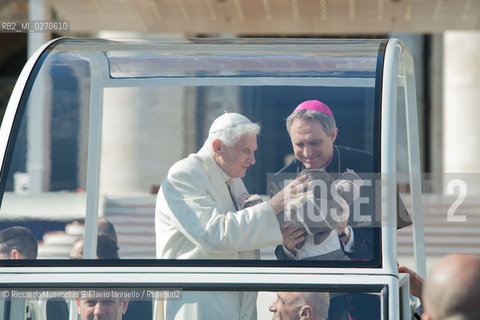 Vatican City Feb 27 2013. Pope Benedict XVI held his last Mass as pontiff at St Peters Square. In the picture: the Holy Father with his secretary Bishop Georg Gaenswain bless a child.  ©Riccardo Musacchio & Flavio Ianniello/Rosebud2