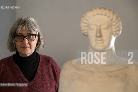 Rome April 11, 2019..Carola Susani, writer, photographed in Rome in the spaces of the Museum of Classical Art of the La Sapienza University, in front of the bust of the 6th century. B.C. coming from Medma/Carola Susani, scrittrice, fotografata a Roma negli spazi del Museo di Arte Classica dellUniversità La Sapienza, davanti al busto del VI sec. a.C. proveniente da Medma. ©Rino Bianchi/Rosebud2