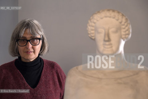 Rome April 11, 2019..Carola Susani, writer, photographed in Rome in the spaces of the Museum of Classical Art of the La Sapienza University, in front of the bust of the 6th century. B.C. coming from Medma/Carola Susani, scrittrice, fotografata a Roma negli spazi del Museo di Arte Classica dellUniversità La Sapienza, davanti al busto del VI sec. a.C. proveniente da Medma. ©Rino Bianchi/Rosebud2