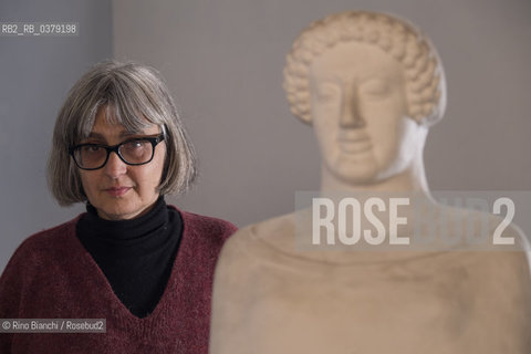 Rome April 11, 2019..Carola Susani, writer, photographed in Rome in the spaces of the Museum of Classical Art of the La Sapienza University, in front of the bust of the 6th century. B.C. coming from Medma/Carola Susani, scrittrice, fotografata a Roma negli spazi del Museo di Arte Classica dellUniversità La Sapienza, davanti al busto del VI sec. a.C. proveniente da Medma. ©Rino Bianchi/Rosebud2