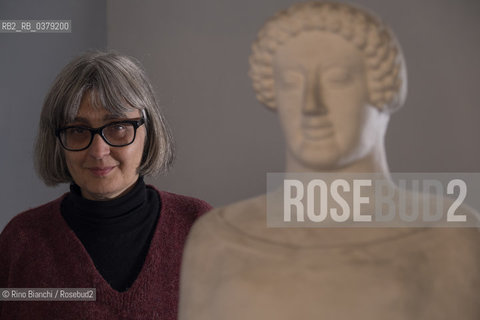 Rome April 11, 2019..Carola Susani, writer, photographed in Rome in the spaces of the Museum of Classical Art of the La Sapienza University, in front of the bust of the 6th century. B.C. coming from Medma/Carola Susani, scrittrice, fotografata a Roma negli spazi del Museo di Arte Classica dellUniversità La Sapienza, davanti al busto del VI sec. a.C. proveniente da Medma. ©Rino Bianchi/Rosebud2