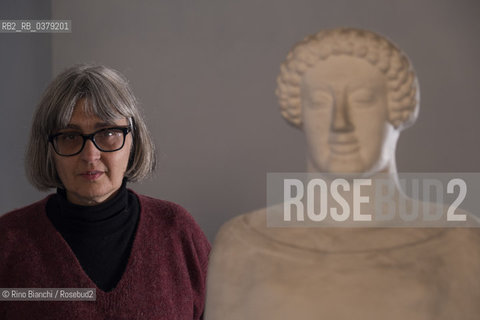 Rome April 11, 2019..Carola Susani, writer, photographed in Rome in the spaces of the Museum of Classical Art of the La Sapienza University, in front of the bust of the 6th century. B.C. coming from Medma/Carola Susani, scrittrice, fotografata a Roma negli spazi del Museo di Arte Classica dellUniversità La Sapienza, davanti al busto del VI sec. a.C. proveniente da Medma. ©Rino Bianchi/Rosebud2