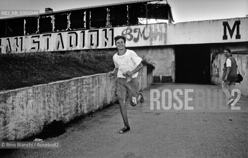 Sarajevo September 1994..The run of the young athlete near the football stadium/La corsa del giovane atleta nei pressi dello stadio di calcio. ©Rino Bianchi/Rosebud2