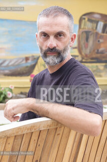 Brancaleone(RC) August 3, 2024..Alessio Torino, writer, Latinist, professor at the University of Urbino, photographed in Brancaleone in the confinement home of Cesare Pavese/Alessio Torino, scrittore, latinista, docente presso lUniversità di Urbino, fotografato a Brancaleone nella dimora di confino di Cesare Pavese. ©Rino Bianchi/Rosebud2