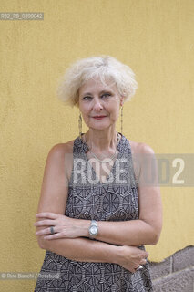 Brancaleone(RC) August 3, 2024..Cecilia Ricciarelli, bookseller, owner of the Italian bookshop Le Nuvole in Barcelona, ​​creator of the Italian Literature Festival of Barcelona (Flib), photographed in Brancaleone in the spaces of Cesare Paveses confinement home/Cecilia Ricciarelli, libraia, titolare della libreria italiana Le Nuvole a Barcellona, ideatrice del Festival Letteratura Italiana di Barcellona(Flib), fotografata a Brancaleone negli spazi della dimora di confino di Cesare Pavese. ©Rino Bianchi/Rosebud2