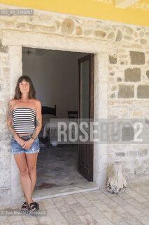 Brancaleone(RC) August 3, 2024..Anna Voltaggio press office specialized in the cultural sector, writer, photographed in Brancaleone at the entrance to the room occupied by Cesare Pavese during the years of confinement/Anna Voltaggio ufficio stampa specializzato nel settore culturale, scrittirice, fotografata a Brancaleone allingresso della stanza occupata da Cesare Pavese durante gli anni del confino. ©Rino Bianchi/Rosebud2