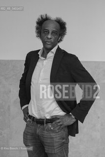 Rome March 21, 2026..Dinaw Mengestu, an Ethiopian-born American writer and novelist, a contributor to Rolling Stone, Harpers, The Wall Street Journal, and many other publications, and director of the written arts program at Bard College, photographed in Rome near Piazza Euclide/Dinaw Mengestu, scrittore e romanziere etiope naturalizzato statunitense, collaboratore delle riviste Rolling Stone,  Harpers, The Wall Street Journal e molte altre pubblicazioni, direttore del programma di arte scritta al Bard College, fotografato a Roma nei pressi di piazza Euclide. ©Rino Bianchi/Rosebud2